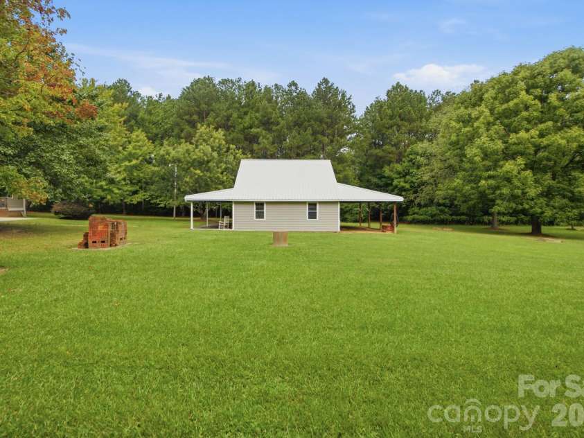 3201 Gilboa Road, Wingate, NC 28174.  MLS# CAR4415181, YatesRealty ID 47454. A profile view - deep lean-to on the back & front porch!