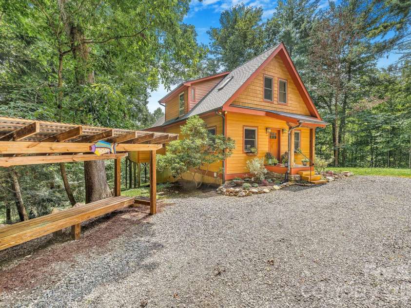 553 River Bend Drive, Mars Hill, NC 28754.  MLS# CAR4418089, YatesRealty ID 47487. Firewood storage along the circular driveway.