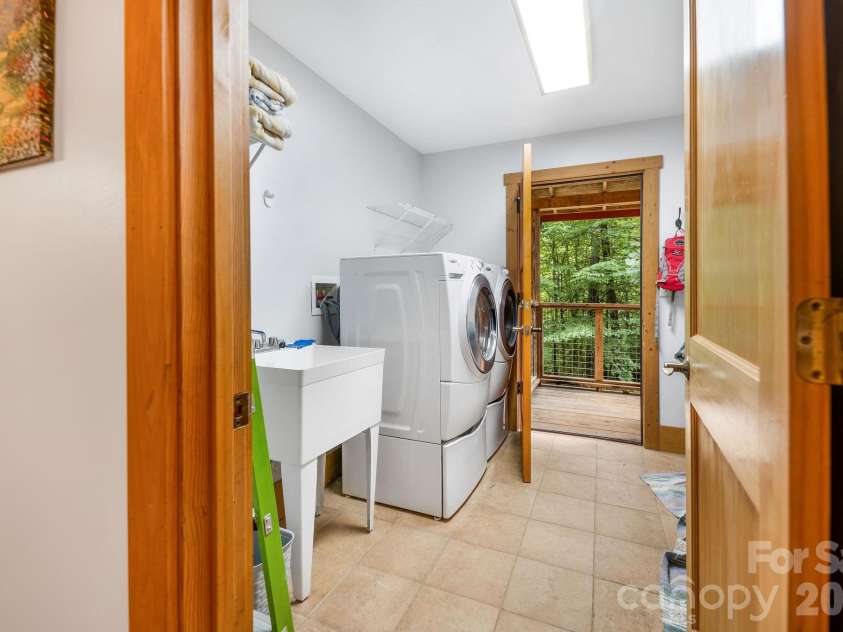 553 River Bend Drive, Mars Hill, NC 28754.  MLS# CAR4418089, YatesRealty ID 47487. Main-floor laundry room also serves as a mudroom to recently hydro seeded side yard.