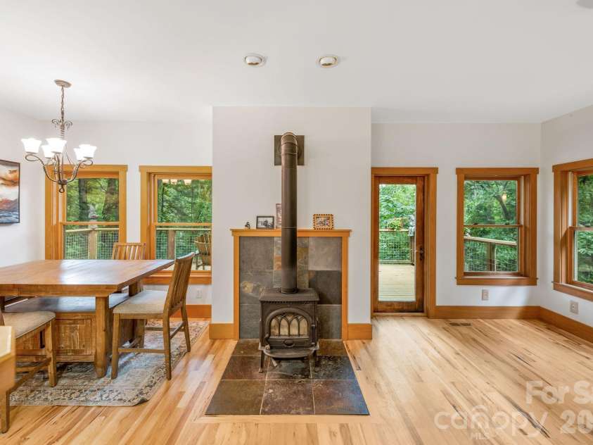 553 River Bend Drive, Mars Hill, NC 28754.  MLS# CAR4418089, YatesRealty ID 47487. Open main-level floor plan centers on a wood-burning stove.