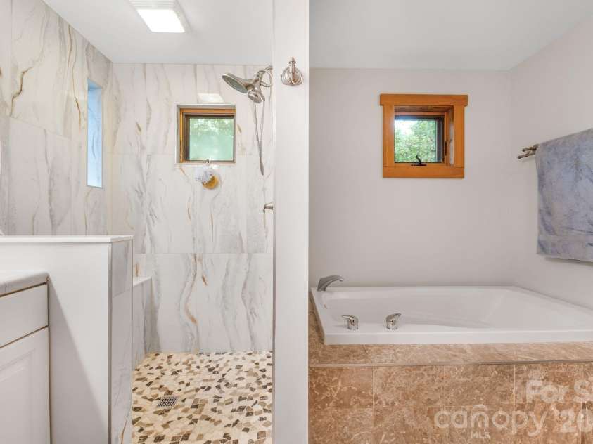 553 River Bend Drive, Mars Hill, NC 28754.  MLS# CAR4418089, YatesRealty ID 47487. Primary suite includes a walk-in shower and separate bathtub