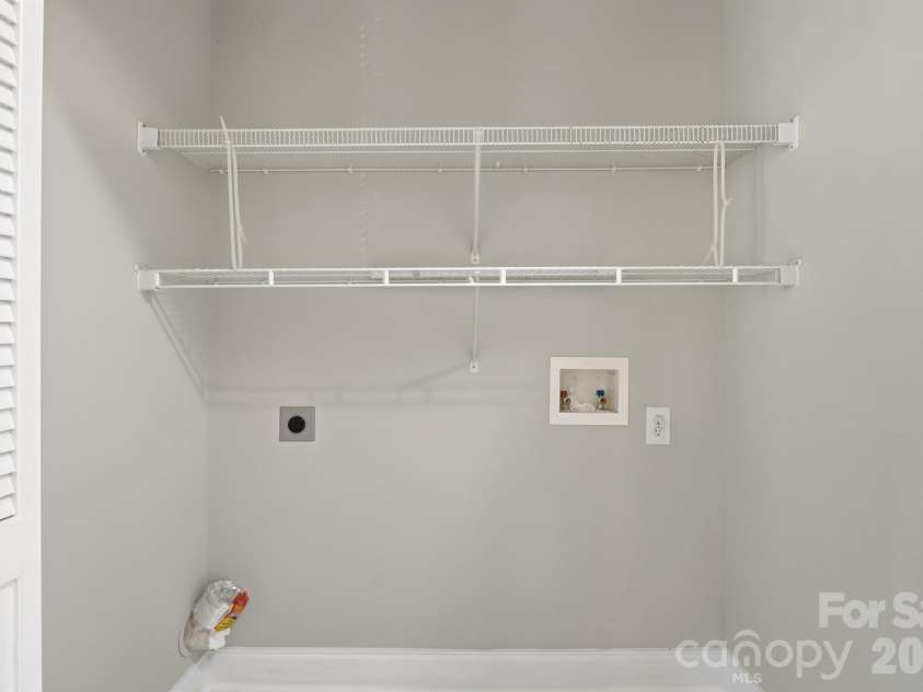 21246 Hickory Street, Cornelius, NC 28031.  MLS# CAR4417839, YatesRealty ID 47488. Laundry closet off kitchen hallway to back balcony