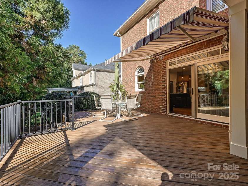 16128 Bridgehampton Club Drive, Charlotte, NC 28277.  MLS# CAR4308778, YatesRealty ID 4753. Back deck off kitchen with motorized retractable canopy.