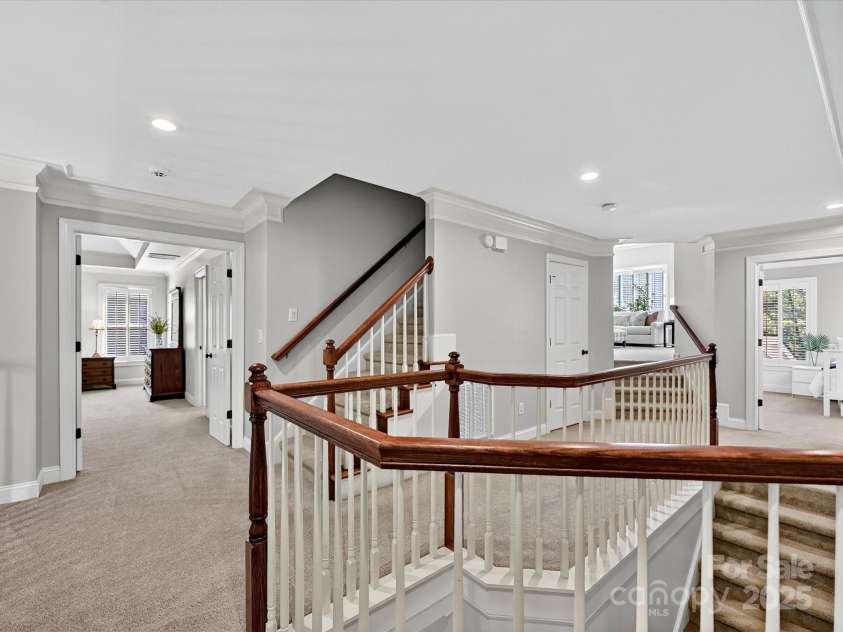 16128 Bridgehampton Club Drive, Charlotte, NC 28277.  MLS# CAR4308778, YatesRealty ID 4753. Second floor hallway. Stairway to third floor.