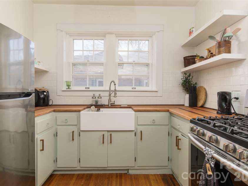 502 Mitchell Avenue, Salisbury, NC 28144.  MLS# CAR4357507, YatesRealty ID 4759. Tile backsplash, butcher block counters, open shelves, farmhouse sink and stylish pulls make this kitchen super cool.