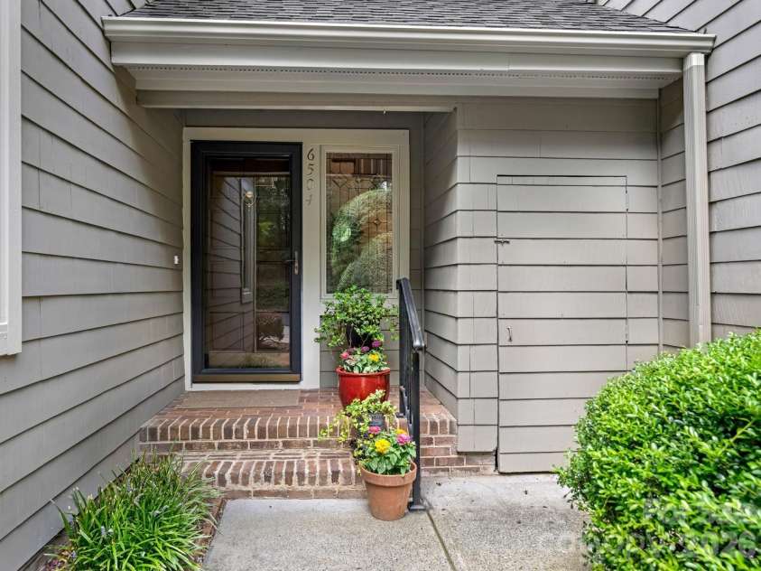 6504 Racquet Wood Court, Charlotte, NC 28226.  MLS# CAR4419127, YatesRealty ID 47601. Covered front entry with storage closet
