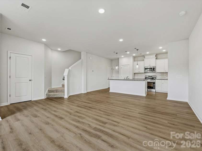 6609 Fire Lily Lane, Charlotte, NC 28216.  MLS# CAR4419428, YatesRealty ID 47646. Spacious Living Room Flowing Seemlessly into Dining Area and Kitchen