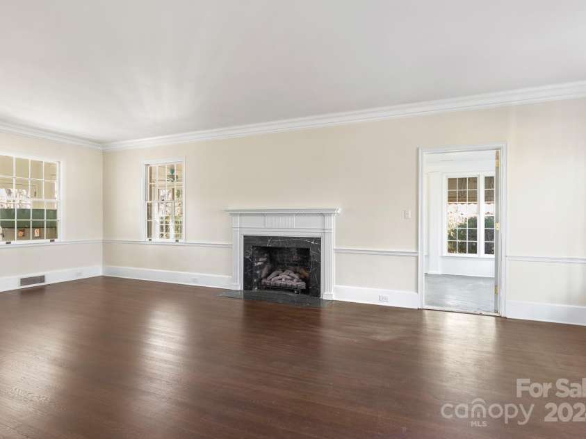 615 Peach Street, Shelby, NC 28150.  MLS# CAR4119174, YatesRealty ID 4771. Spacious living room and the adjacent wrap-around sunroom