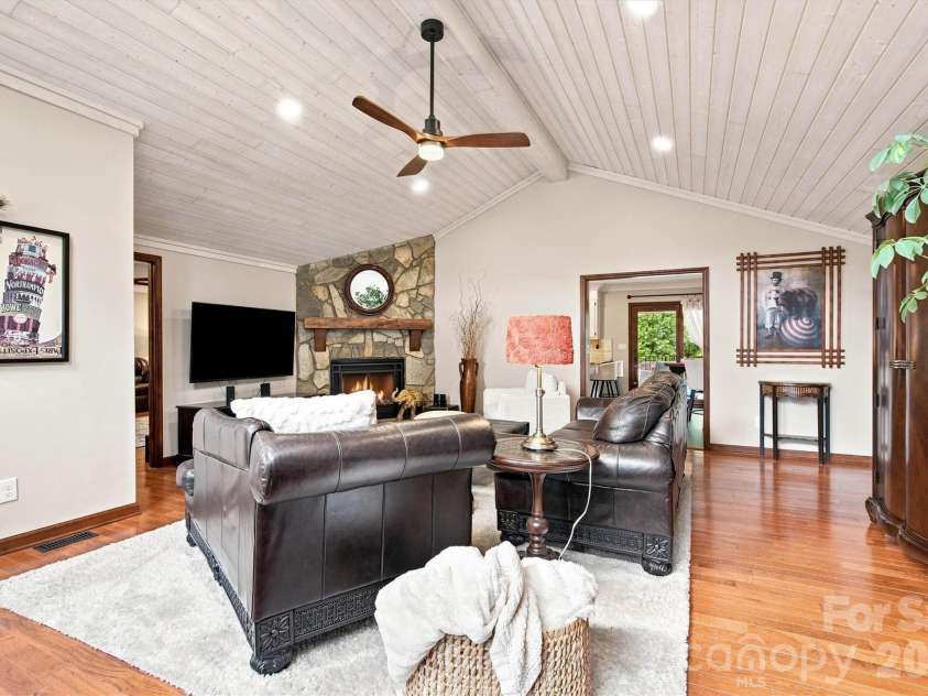 3867 Angie Drive, Denver, NC 28037.  MLS# CAR4413500, YatesRealty ID 47745. Stunning floor-to-ceiling stone fireplace featuring a handcrafted solid walnut mantel, serving as a sophisticated focal point for this expansive family room.