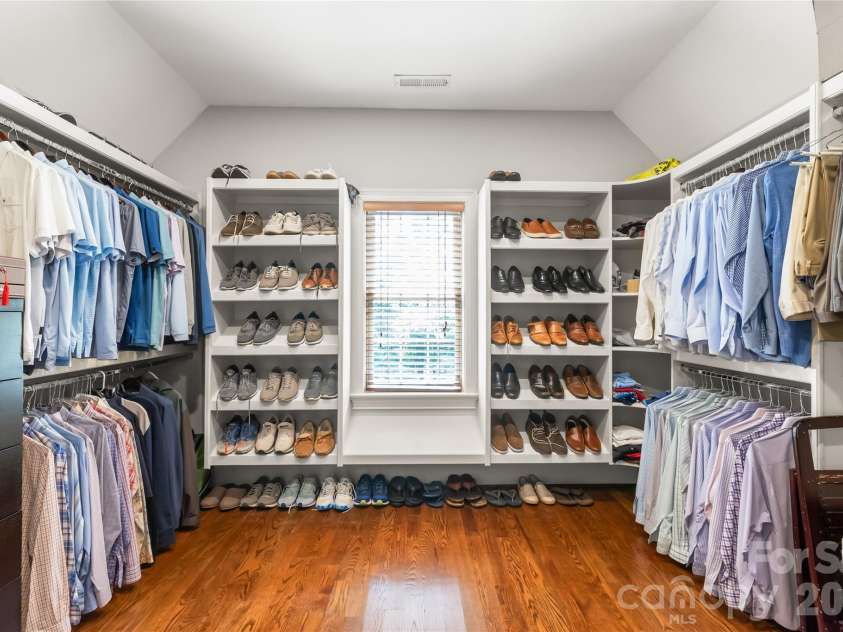 7320 Summerlin Place, Charlotte, NC 28226.  MLS# CAR4418024, YatesRealty ID 47825. A custom walk-in closet equipped with tailored shelving and organization systems to keep everything neatly in place.