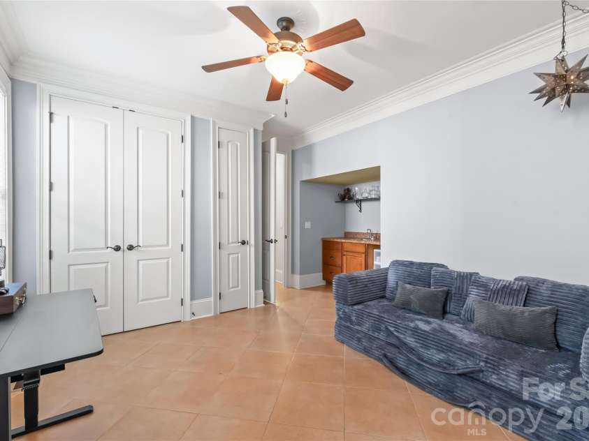 7320 Summerlin Place, Charlotte, NC 28226.  MLS# CAR4418024, YatesRealty ID 47825. Eight-foot solid interior doors frame this space, complete with a wet bar and a private entrance for effortless entertaining or guest access.