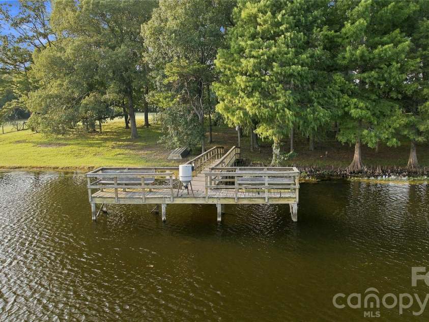 1979 Willie Usher Road, Lancaster, SC 29720.  MLS# CAR4410738, YatesRealty ID 47845. Log home hidden beneath the tree canopy