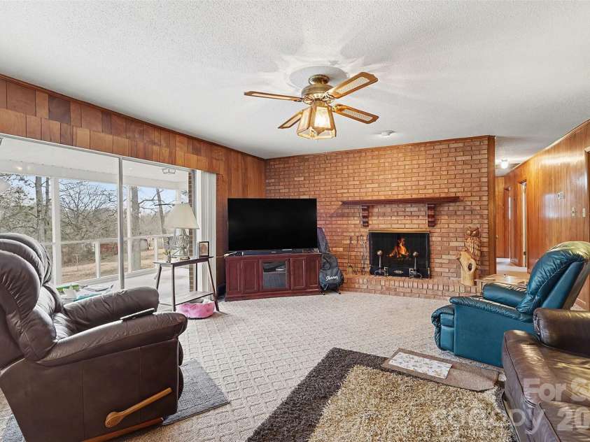 2401 Penninger Road, Concord, NC 28025.  MLS# CAR4344658, YatesRealty ID 4786. Fire in fireplace is photo shopped. Check out the view of the property you have from this comfortable cozy room!