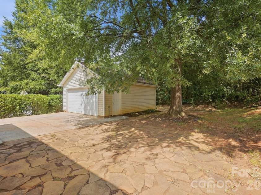 11402 Heritage Green Drive, Cornelius, NC 28031.  MLS# CAR4413381, YatesRealty ID 47889. Flagstone pavered patio with large shade tree