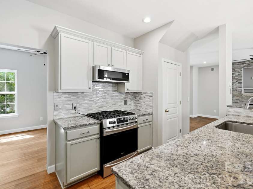 11402 Heritage Green Drive, Cornelius, NC 28031.  MLS# CAR4413381, YatesRealty ID 47889. Gas stove with low profile convection microwave