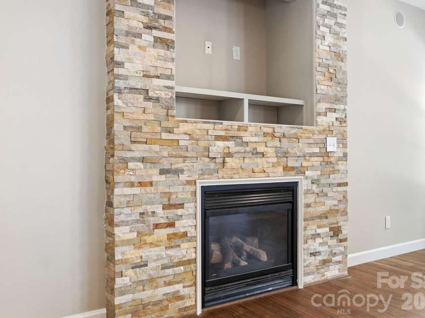 11402 Heritage Green Drive, Cornelius, NC 28031.  MLS# CAR4413381, YatesRealty ID 47889. Stacked stone gas fireplace