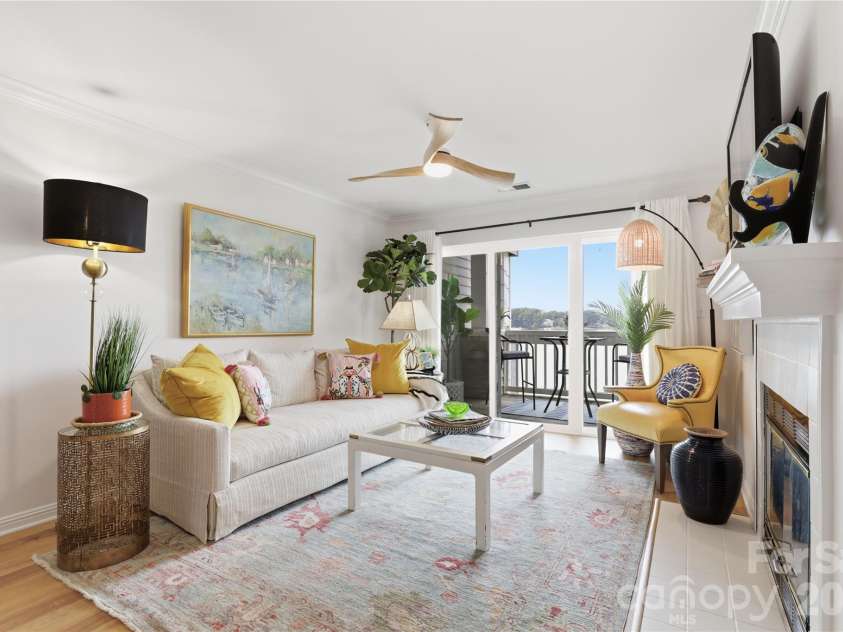 932 Southwest Drive, Davidson, NC 28036.  MLS# CAR4414444, YatesRealty ID 47906. Great room featuring waterfront scenery and a cozy fireplace.