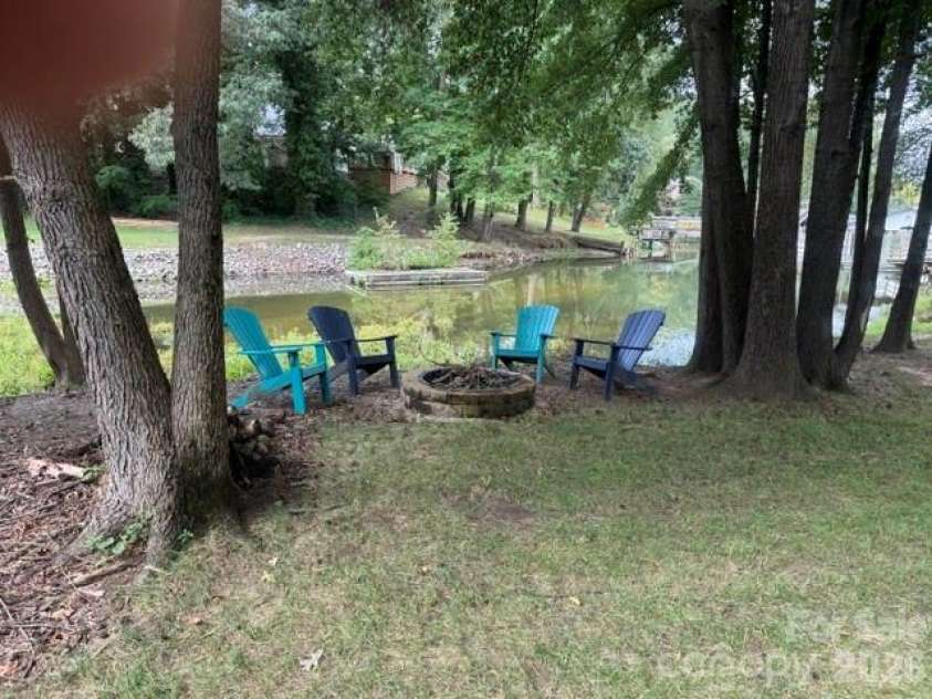 150 Shady Cove Drive, Troutman, NC 28166.  MLS# CAR4419626, YatesRealty ID 47923. Out door lakeside firepit