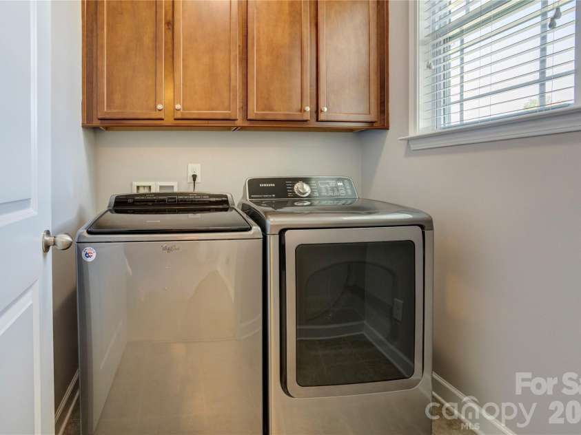 255 Perennial Drive, Concord, NC 28027.  MLS# CAR4417851, YatesRealty ID 47934. Laundry room with storage cabinets.