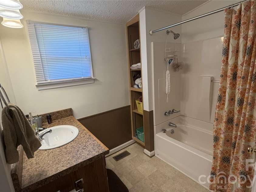 209 Auten Circle, Mount Holly, NC 28120.  MLS# CAR4414320, YatesRealty ID 47945. Bathroom located between both bedrooms