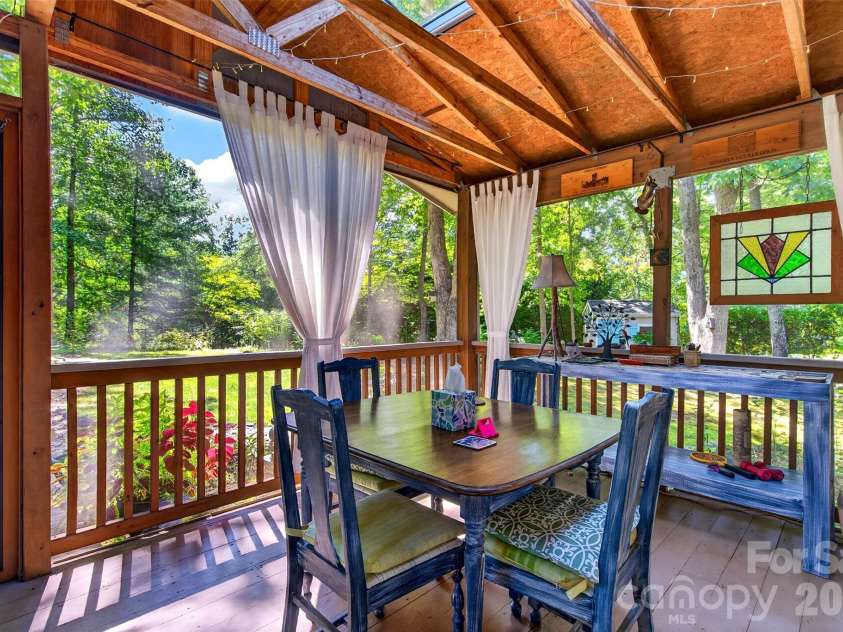 42 Timothy Lane, Candler, NC 28715.  MLS# CAR4419868, YatesRealty ID 47953. Peacefully surrounded by garden beds and greenery