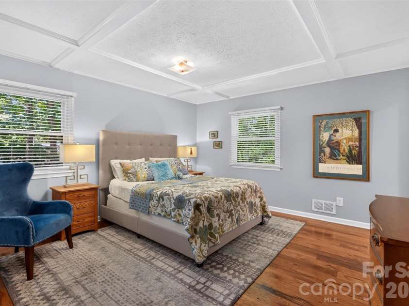 42 Timothy Lane, Candler, NC 28715.  MLS# CAR4419868, YatesRealty ID 47953. Primary bedroom - custom ceiling finishes complement the hardwoods
