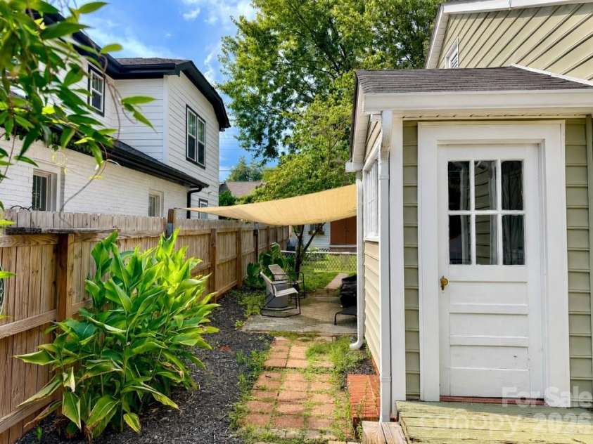 3407 Benard Avenue, Charlotte, NC 28206.  MLS# CAR4414465, YatesRealty ID 47981. Shaded side-yard walkway framed by established landscaping.