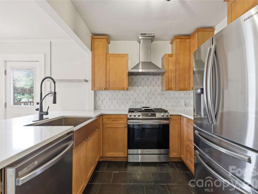 3407 Benard Avenue, Charlotte, NC 28206.  MLS# CAR4414465, YatesRealty ID 47981. Updated kitchen featuring quartz countertops and stainless steel appliances.