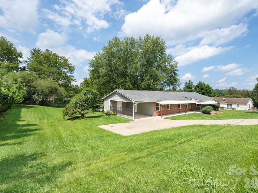483 Caribou Road, Asheville, NC 28803.  MLS# CAR4417603, YatesRealty ID 47992. Facing house - left side