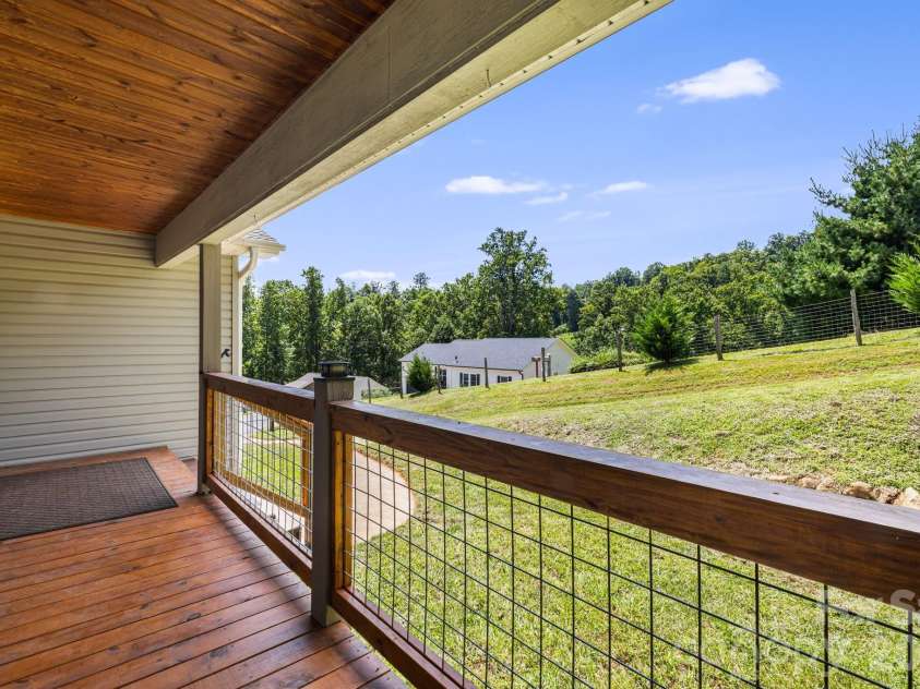 184 Scarlett Ridge Drive, Marshall, NC 28753.  MLS# CAR4416325, YatesRealty ID 47997. Front porch looking left