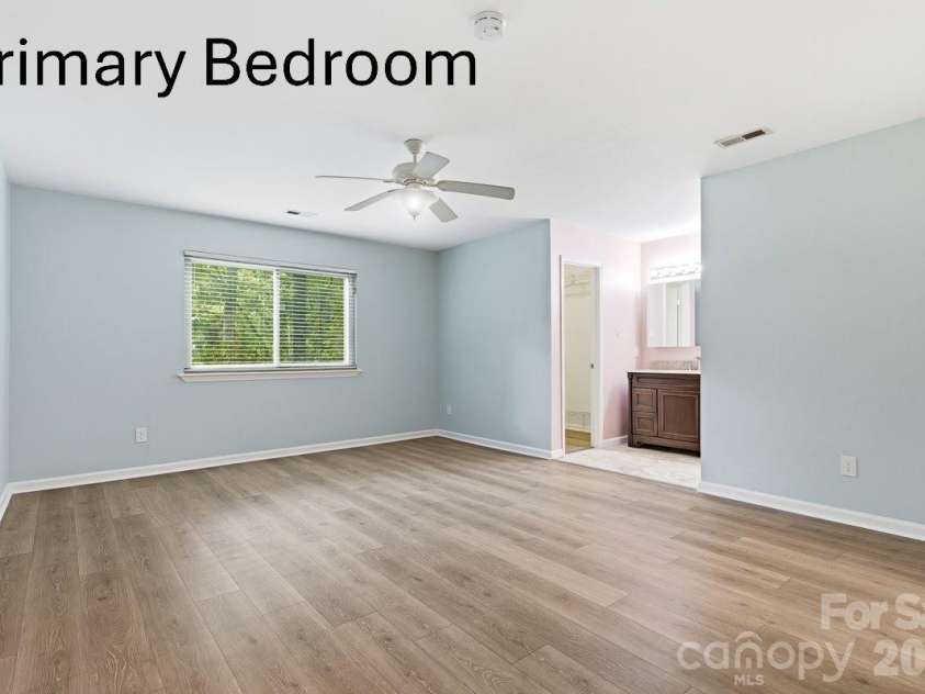 326 Vista Grande Circle, Charlotte, NC 28226.  MLS# CAR4418981, YatesRealty ID 48012. Spacious primary with ceiling fan.  Has 2 walk in closets.  One was turned into a computer area but easily can be true closet again.