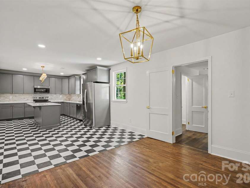 601 Marion Sims Drive, Lancaster, SC 29720.  MLS# CAR4404710, YatesRealty ID 48048. Open-concept layout highlighting the seamless transition from the kitchen into the adjoining hardwood dining/living space.