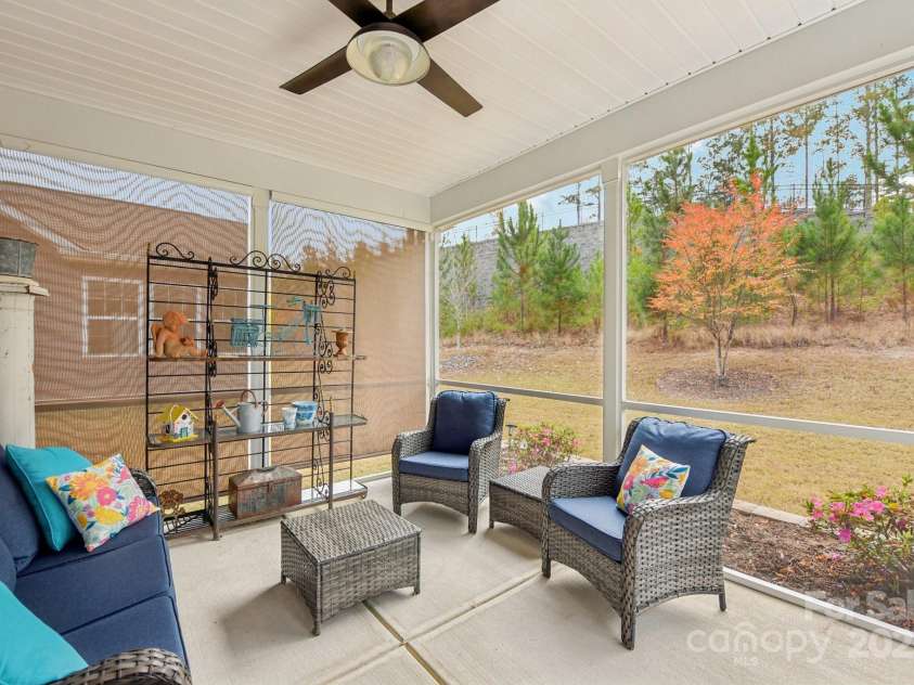 1328 Dali Boulevard, Mount Holly, NC 28120.  MLS# CAR4320263, YatesRealty ID 48061. Enjoy your morning cup of tea or coffee on this screened in porch accessed from the dining area. There are pull down shades to provide privacy and comfort.