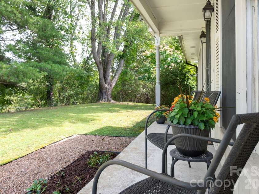 1057 Skyway Drive, Marshall, NC 28753.  MLS# CAR4418857, YatesRealty ID 48112. Covered front porch overlooking the yard