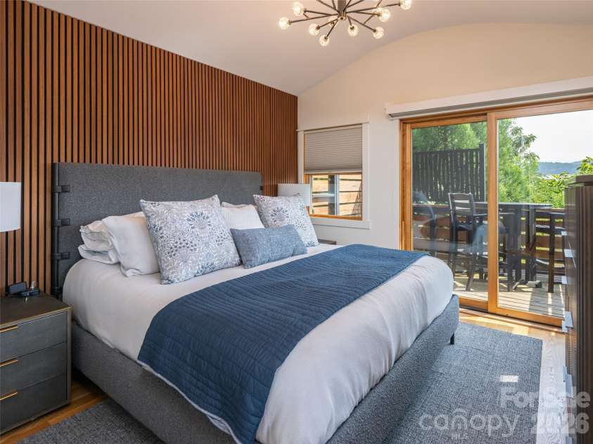 4 Osprey Trail, Asheville, NC 28806.  MLS# CAR4418286, YatesRealty ID 48114. Primary Bedroom with feature wall and viewing deck