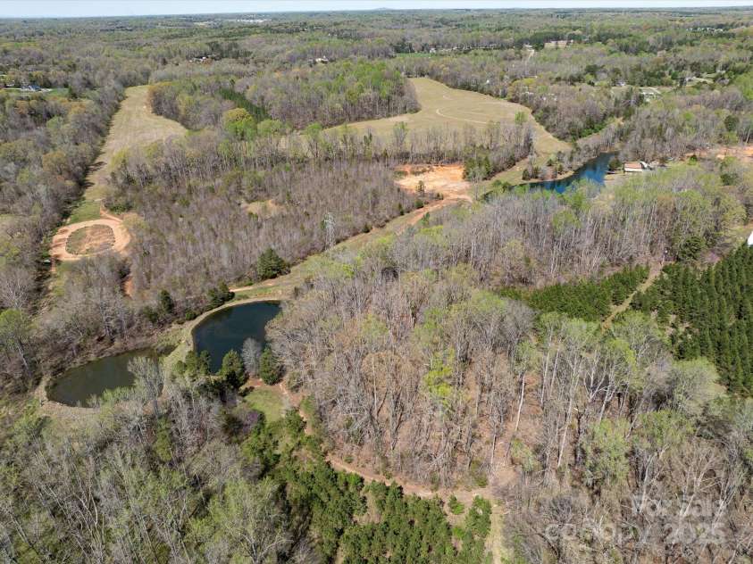 7545 Brancy Street, Kannapolis, NC 28081.  MLS# CAR4242395, YatesRealty ID 4813. 21.71 Acre Retreat with Private Pond, race track, multiple garages , sheds and a workshop!