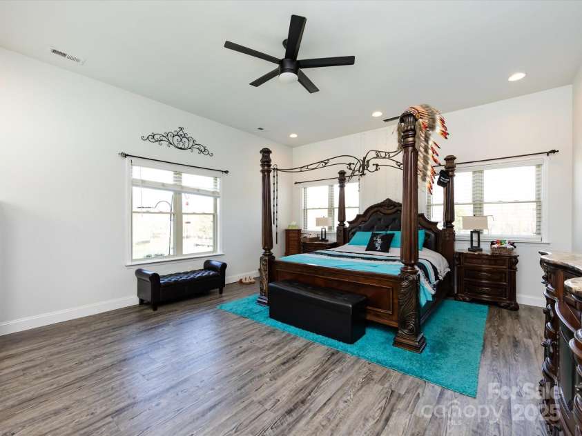 7545 Brancy Street, Kannapolis, NC 28081.  MLS# CAR4242395, YatesRealty ID 4813. Huge Primary Bedroom featuring primary bath, large walk in closet, vinyl plank flooring, recessed lighting and ceiling fan.