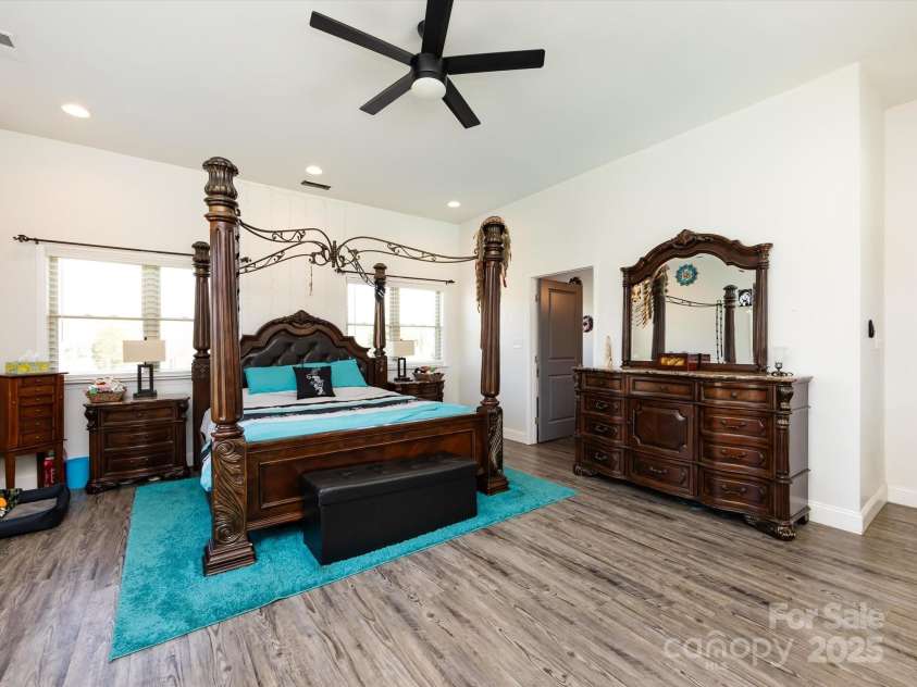 7545 Brancy Street, Kannapolis, NC 28081.  MLS# CAR4242395, YatesRealty ID 4813. Huge Primary Bedroom featuring primary bath, large walk in closet, vinyl plank flooring, recessed lighting and ceiling fan.