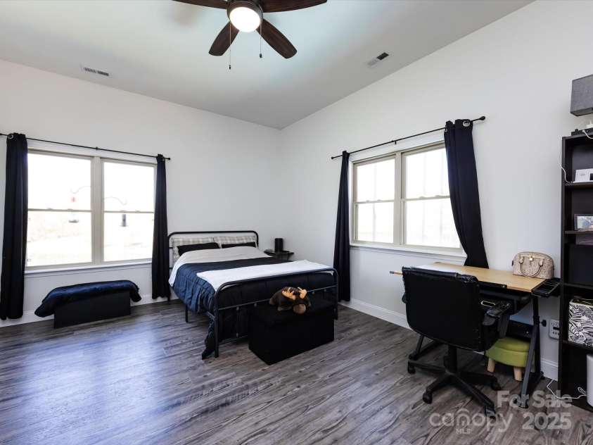 7545 Brancy Street, Kannapolis, NC 28081.  MLS# CAR4242395, YatesRealty ID 4813. Large 4th Bedroom features a private bathroom, walk in closet, vinyl plank flooring, ceiling fan/light.