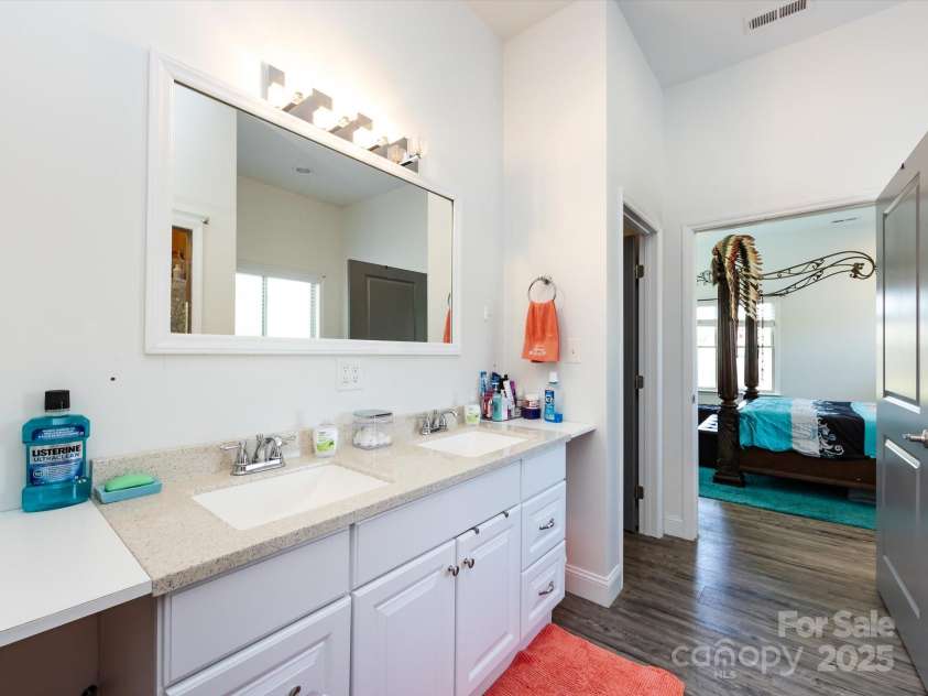 7545 Brancy Street, Kannapolis, NC 28081.  MLS# CAR4242395, YatesRealty ID 4813. Primary Bath with double sinks, enclosed shower, garden tub and towel closet.  Connected to the large walk in closet!