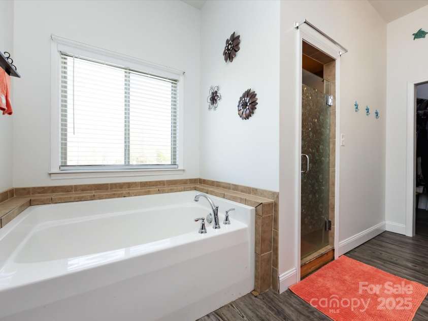 7545 Brancy Street, Kannapolis, NC 28081.  MLS# CAR4242395, YatesRealty ID 4813. Primary Bath with double sinks, garden tub, enclosed shower and towel closet.  Connected to the large walk in closet!