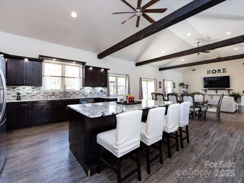 7545 Brancy Street, Kannapolis, NC 28081.  MLS# CAR4242395, YatesRealty ID 4813. Stunning Kitchen boasting an open floor plan , walk in pantry, exotic granite countertops, huge breakfast bar, tiled backsplash, stainless steel appliances, large sink and tons of cabinets with accent lighting. The kitc