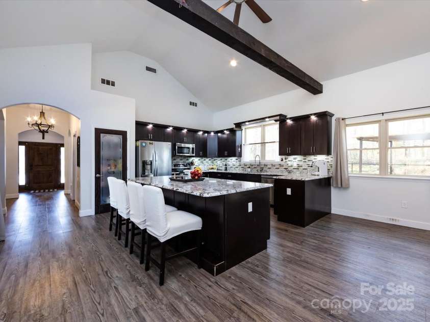 7545 Brancy Street, Kannapolis, NC 28081.  MLS# CAR4242395, YatesRealty ID 4813. Stunning Kitchen boasting an open floor plan , walk in pantry, exotic granite countertops, huge breakfast bar, tiled backsplash, stainless steel appliances, large sink and tons of cabinets with accent lighting. The kitc