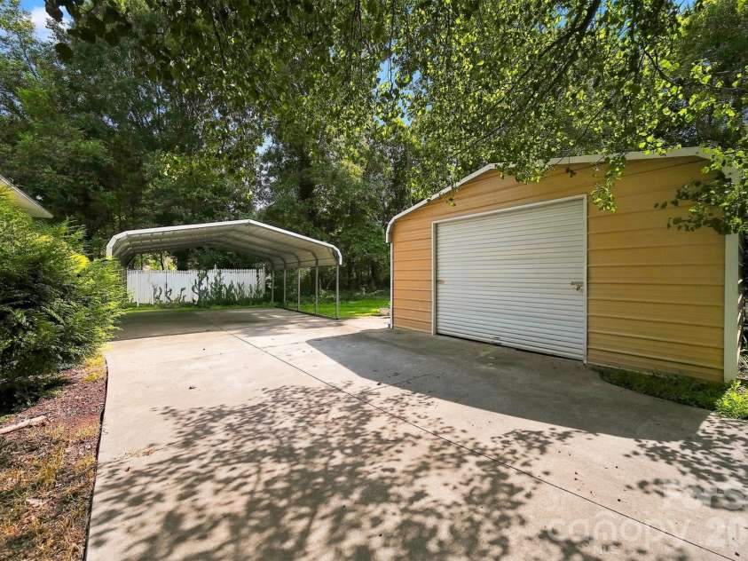 717 2nd Street Place, Conover, NC 28613.  MLS# CAR4420302, YatesRealty ID 48145. Side Yard with carport and detached garage