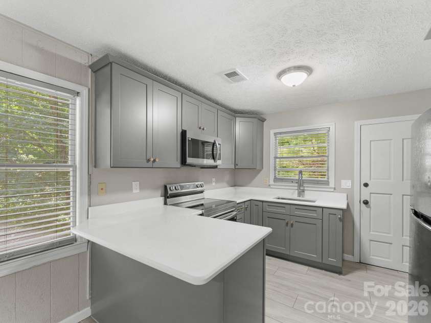 71 Harvey Osteen Road, Zirconia, NC 28790.  MLS# CAR4418072, YatesRealty ID 48166. Unit 2 Kitchen w/Breakfast Bar