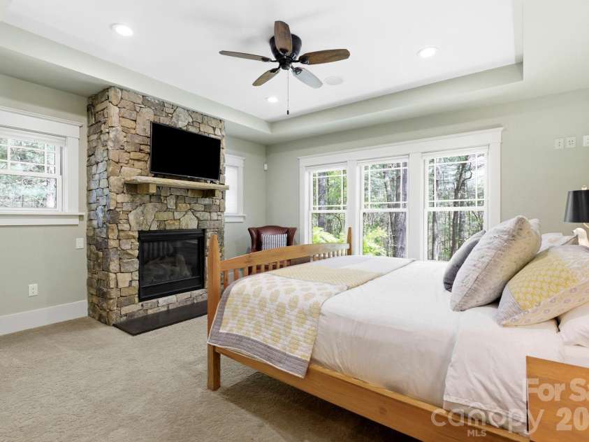 31 Ashbrook Meadows, Fletcher, NC 28732.  MLS# CAR4374375, YatesRealty ID 48210. Primary bedroom with gas fireplace