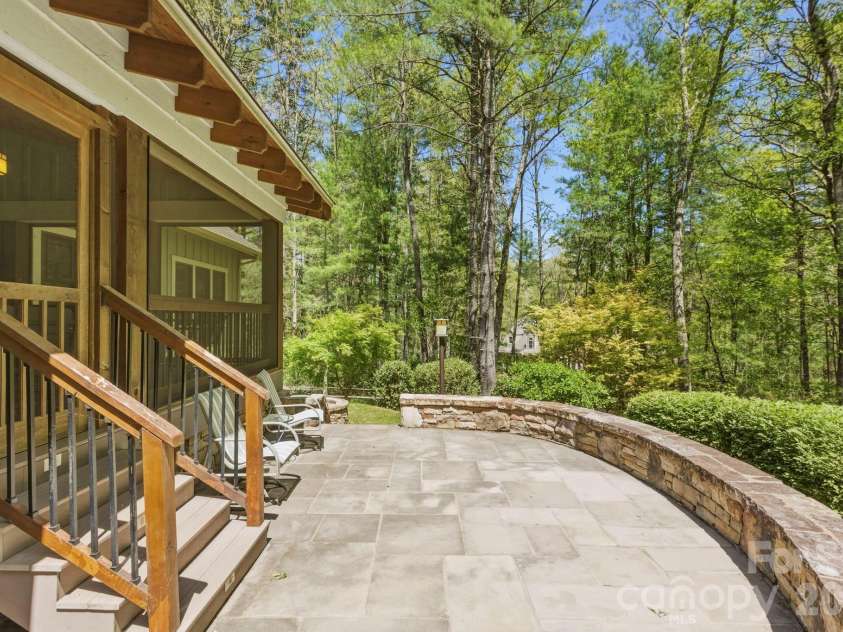 31 Ashbrook Meadows, Fletcher, NC 28732.  MLS# CAR4374375, YatesRealty ID 48210. Stone patio overlooking the backyard