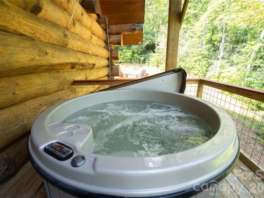 142 Southwood Drive, Brevard, NC 28712.  MLS# CAR4420666, YatesRealty ID 48250. Main level deck hot tub