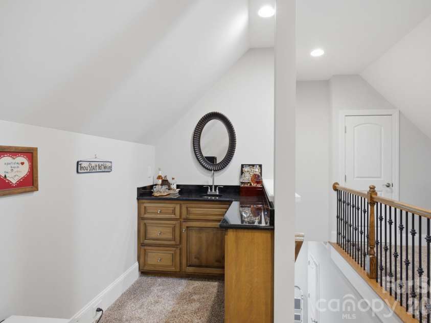 7197 Windy Ridge Drive, Iron Station, NC 28080.  MLS# CAR4417271, YatesRealty ID 48262. Bar in the bonus room increases the functionality