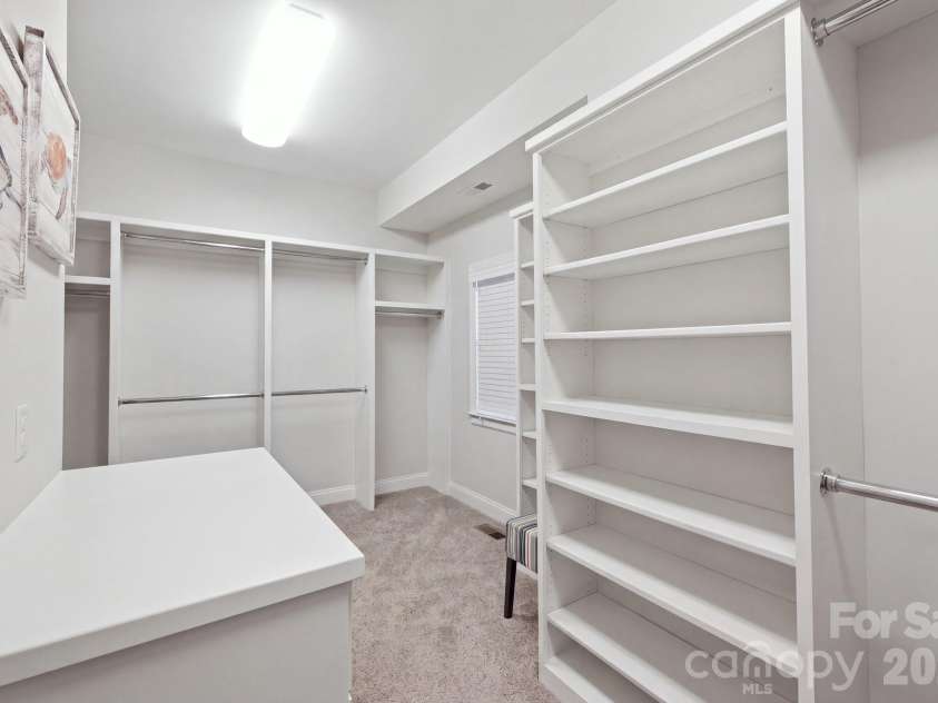 7197 Windy Ridge Drive, Iron Station, NC 28080.  MLS# CAR4417271, YatesRealty ID 48262. Expansive primary closet with items virtually removed